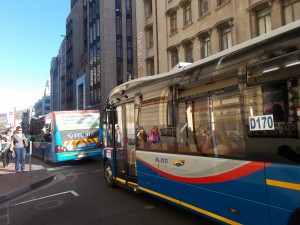 passengers wait to board a MyCiTi bus in Cape Town city centre